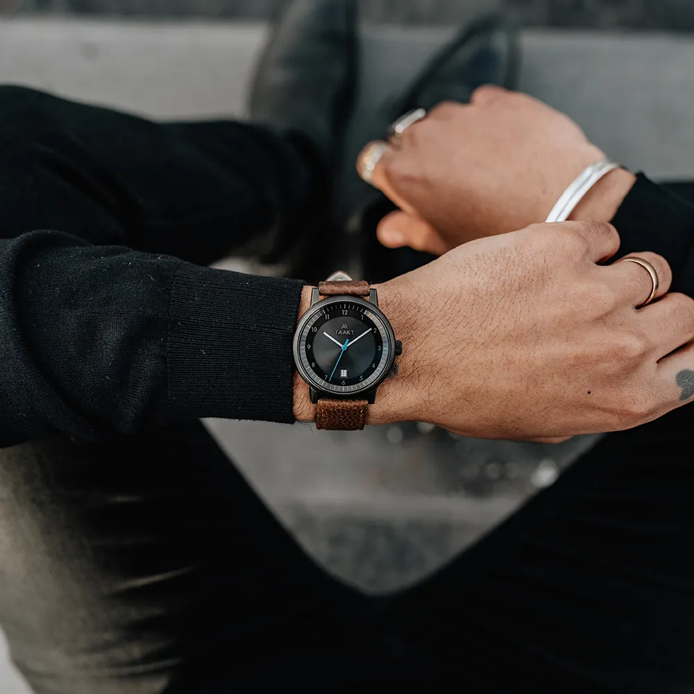 Checking the time, a black Aspect on brown leather, rings on the other hand