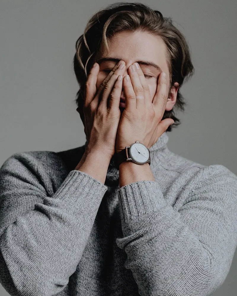 A silver Aspect on brown leather, worn with a gray wool sweater