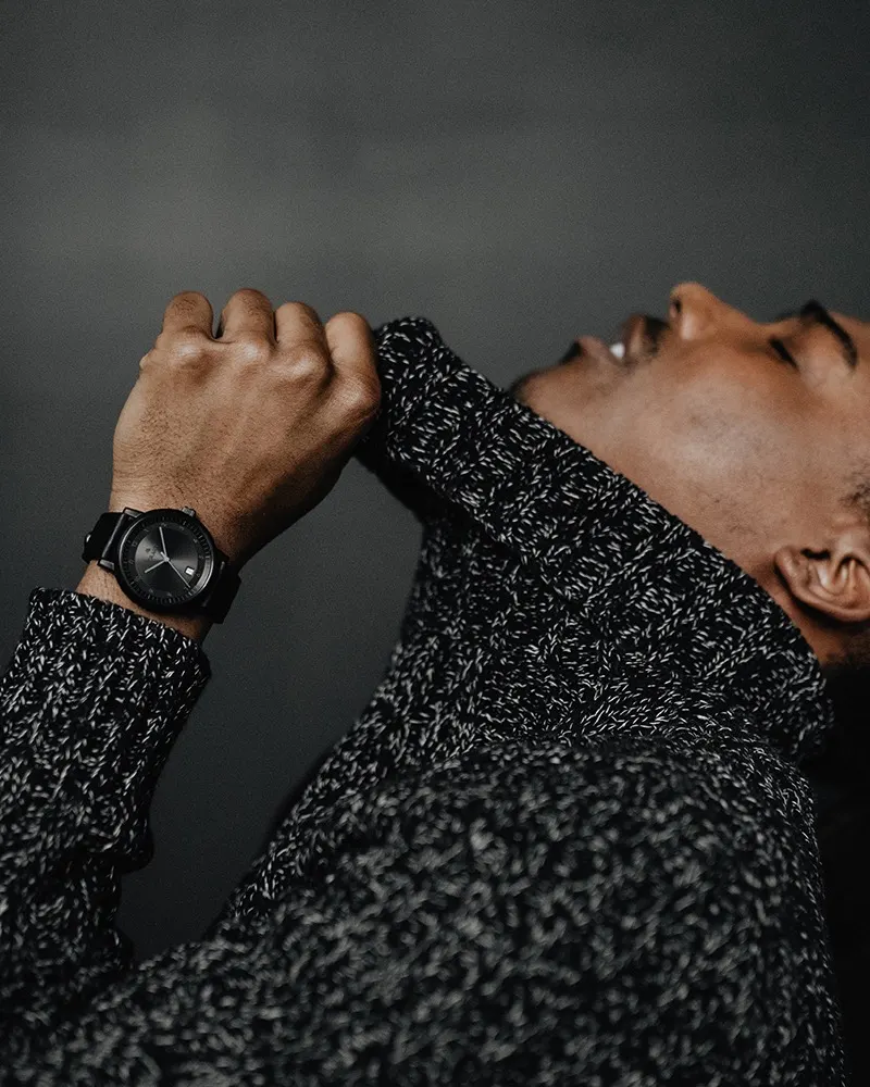 A black Aspect on black leather, worn with a marled knit